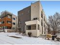 Modern multi-level home with contemporary architectural details and neutral color palette nestled into a snow covered landscape at 1246 Xavier St, Denver, CO 80204