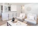 Open-concept living area showcases a stylish breakfast bar with seating and contemporary decor at 1476 W Dakota Ave, Denver, CO 80223