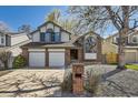 Charming two-story home featuring a two-car garage, well-maintained landscaping, and brick accents at 6726 Taft Cir, Arvada, CO 80004