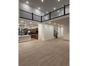 Open-concept living space with high ceilings, wood floors, and modern staircase at 5621 W 141St Ln, Broomfield, CO 80020