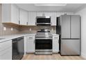 Modern kitchen showcasing stainless steel appliances and ample counter space at 12635 E Pacific Cir # A, Aurora, CO 80014