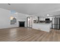 Open floor plan featuring a fireplace, ample lighting and a modern kitchen with stainless appliances at 12635 E Pacific Cir # A, Aurora, CO 80014
