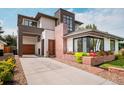 Beautifully landscaped modern home with a brick encased flower bed and an attached garage at 111 S Hudson St, Denver, CO 80246