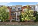 Attractive multi-level townhouse featuring brick and siding with small balconies and lovely trees at 85 Uinta Way # 603, Denver, CO 80230