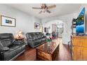Inviting living room featuring hardwood floors, plush leather seating, and seamless access to the dining area at 85 Uinta Way # 603, Denver, CO 80230