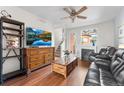 Comfortable living room with dark leather seating, wood accents, a modern fireplace, and a view of the stairway at 85 Uinta Way # 603, Denver, CO 80230