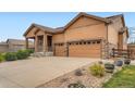 Charming single-Gathering home featuring a two-car garage, covered front porch, and drought resistant landscaping at 23993 E Briarwood Dr, Aurora, CO 80016
