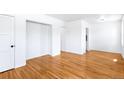 Spacious bedroom with hardwood floors, fresh white paint, and ample closet space at 1168 Kearney St, Denver, CO 80220