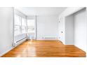 Bright living room featuring hardwood floors, large windows, and neutral paint for a modern aesthetic at 1168 Kearney St, Denver, CO 80220