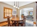 Warm dining area featuring hardwood floors, wood trim, and view to living area at 3051 W 39Th Ave, Denver, CO 80211