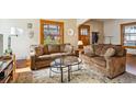 Inviting living room with cozy couches, decorative rug, and abundant natural light at 3051 W 39Th Ave, Denver, CO 80211