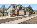Charming townhome features a two-car garage and a welcoming front porch with seating area at 3109 Newport Cir, Castle Rock, CO 80104