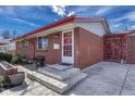 Close up of a brick home featuring a tidy entryway with a mailbox and a small porch at 6719 Quay St, Arvada, CO 80003