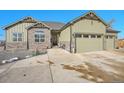 Two-story house with stone and green siding, three car garage at 7301 E 82Nd Pl, Commerce City, CO 80022