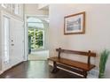 Bright and spacious entryway with hardwood floors and a wooden bench at 1430 Milbury St, Castle Rock, CO 80104