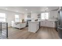A stylish open-concept living room and kitchen with modern finishes and ample natural light at 9306 Clermont Dr, Thornton, CO 80229