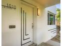 Stylish front door with modern design elements and house number '1010' is a welcoming entrance to this lovely home at 1010 N Jasmine St, Denver, CO 80220