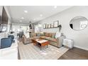 Bright living room with a cozy sectional, open to the dining area and kitchen at 3938 Kalamath St, Denver, CO 80211