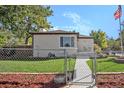Cozy single-story house featuring a fenced yard and well-kept lawn at 3790 W 54Th Ave, Denver, CO 80221
