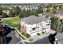 An inviting exterior view of a condo complex with lush greenery and well-maintained landscaping at 9861 E Carolina Pl, Aurora, CO 80247