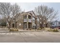 Exterior view of the apartment building featuring balconies, stone accents and drought tolerant landscaping at 7440 S Blackhawk St # 15-202, Englewood, CO 80112