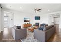 Bright living room features stylish furniture, a fireplace, and a ceiling fan at 27196 E Alder Dr, Aurora, CO 80016