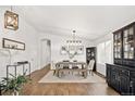 Bright dining room features a wood table, bench, and built-in hutch at 5935 E 129Th Pl, Thornton, CO 80602