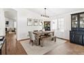 Bright dining room features a wood table, bench, and built-in hutch at 5935 E 129Th Pl, Thornton, CO 80602