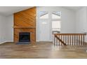 Cozy living room with a charming wooden fireplace and an inviting front entryway at 7722 S Steele St, Centennial, CO 80122