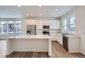 Modern kitchen featuring white cabinetry, an island, and stainless steel appliances at 14556 W 91St Ave # A, Arvada, CO 80005