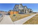 Well-manicured lawn on a beautiful townhome with sidewalk, fencing, and street views at 28304 E 6Th Pl, Watkins, CO 80137