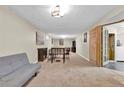 Spacious finished basement with neutral carpeting, a comfortable seating area, and ample room for entertaining at 6434 S Dudley Way, Littleton, CO 80123