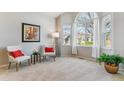 Bright living room with large arched windows, neutral tones, and stylish furnishings at 10470 W Cooper Pl, Littleton, CO 80127
