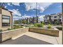 View of modern townhomes with well-maintained landscaping and a concrete patio at 6849 E Lowry Blvd, Denver, CO 80230