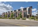 Row of modern townhomes with brick accents, large windows, and street landscaping at 6849 E Lowry Blvd, Denver, CO 80230
