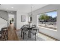 Cozy dining area features a round table, stylish chairs, hardwood floors, and lots of natural light at 1335 N Alton St, Aurora, CO 80010