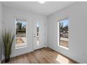 Sunlit entryway with wood flooring and large windows, offering a welcoming feel at 1335 N Alton St, Aurora, CO 80010