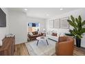 Cozy living room featuring stylish furniture, hardwood floors, and ample natural light at 1335 N Alton St, Aurora, CO 80010