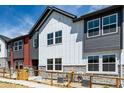 Modern townhome exterior showcasing a blend of white siding, grey accents, and large windows at 2887 E 103Rd Dr, Thornton, CO 80229