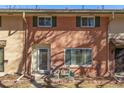 Charming brick townhome facade with updated windows, a small front patio, and well-maintained landscaping at 550 S Xenon Ct, Lakewood, CO 80228