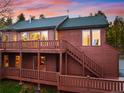 Stunning two-story home with a large deck and beautiful wood accents at 11163 Conifer Mountain Rd, Conifer, CO 80433