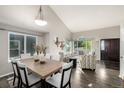 Open-concept dining room features a contemporary table set and bright natural light from nearby windows at 670 Somerset Dr, Golden, CO 80401