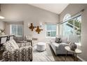 Bright living room with contemporary furniture, vaulted ceiling, and large windows for ample natural light at 670 Somerset Dr, Golden, CO 80401