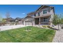 Charming two-story home with a well-manicured lawn, neutral-toned exterior, and three car garage at 6065 Clover Ridge Cir, Castle Rock, CO 80104