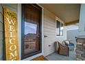 Inviting front porch with comfortable seating and a charming 'Welcome' sign at 6065 Clover Ridge Cir, Castle Rock, CO 80104