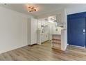 Well-lit kitchen featuring white cabinets, modern appliances, and hardwood-style floors at 8555 Fairmount Dr # C202, Denver, CO 80247