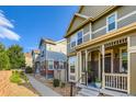 Charming two-story home featuring a well-maintained yard and inviting front porch at 14641 E Poundstone Dr, Aurora, CO 80015