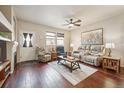 Spacious living room with hardwood floors, fireplace and recessed lighting at 25077 E Canal Pl, Aurora, CO 80018