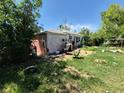 An overgrown backyard of a single Gathering house with assorted objects at 1266 Del Mar Pkwy, Aurora, CO 80010