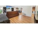 Cozy living room featuring hardwood floors and an open layout to the dining area at 6462 E Bates Ave, Denver, CO 80222